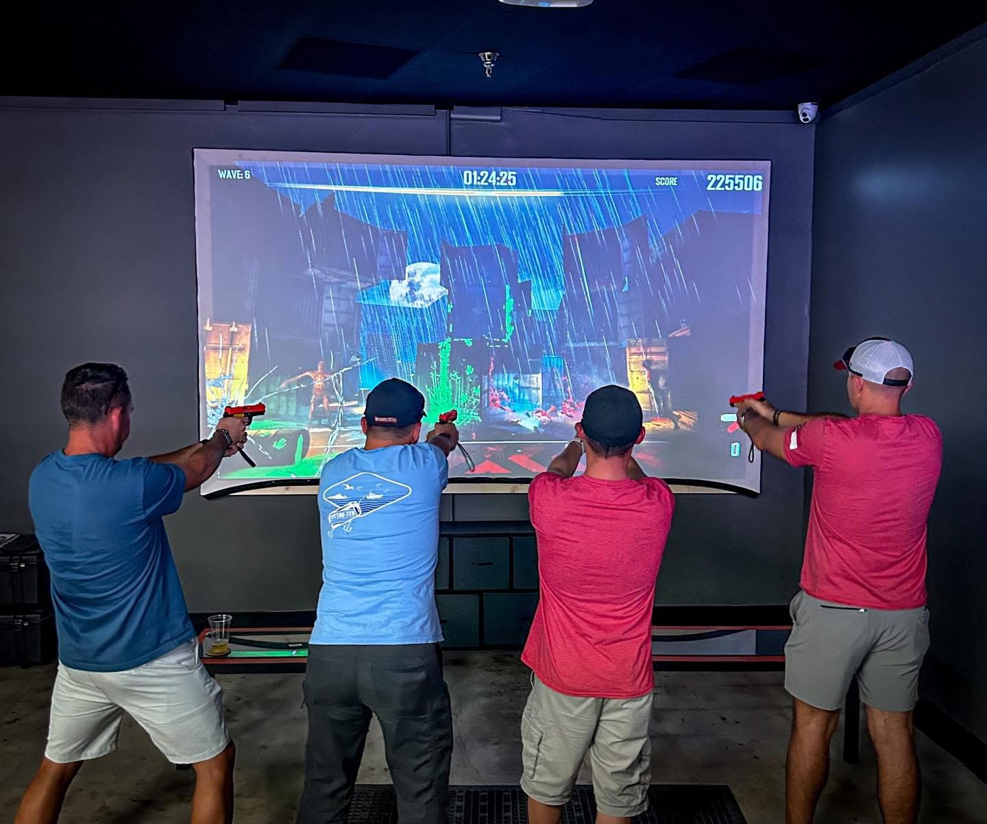 Friends playing laser shot simulator at Sol's Arcade