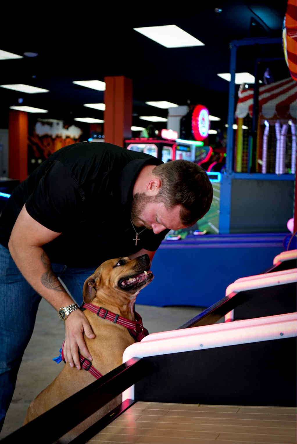 Owner with Sol the dog at the arcade